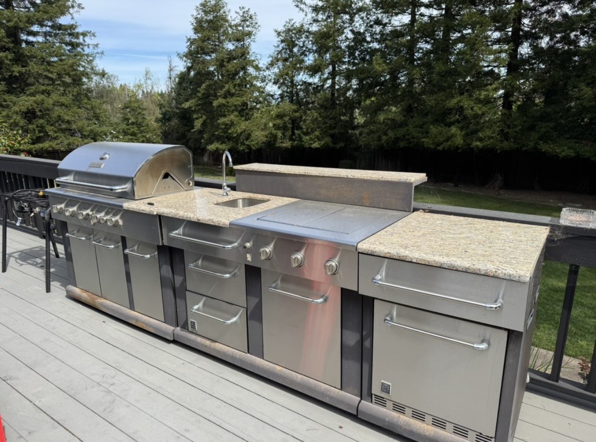 Large outdoor stove, sink, and kitchen before removal