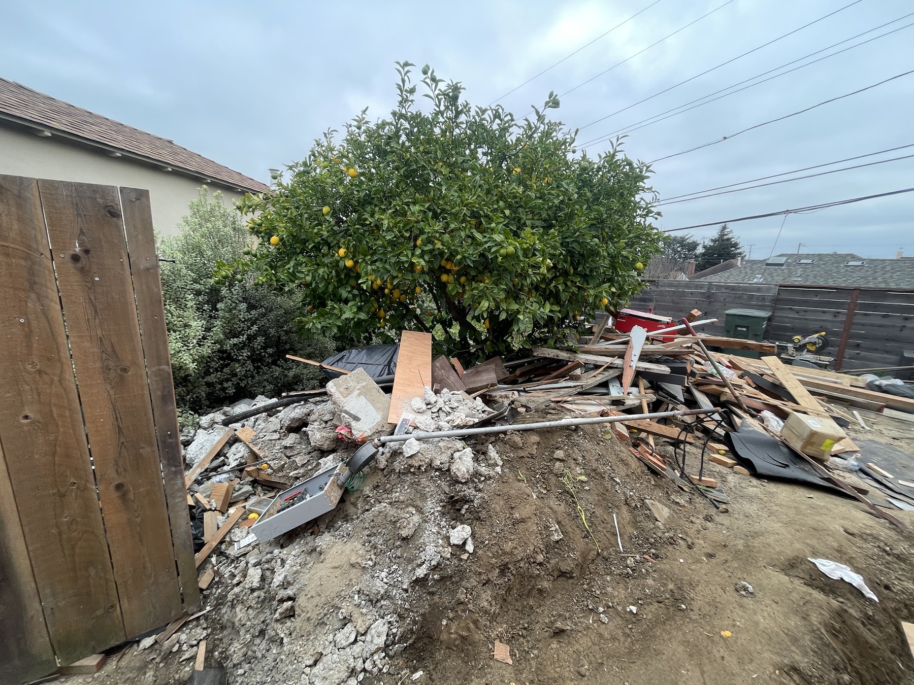 Construction debris piled in a backyard before removal